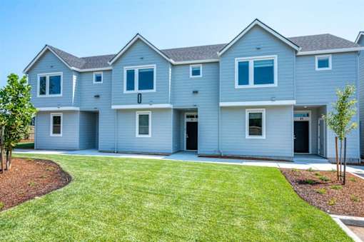 A row of houses with blue siding and white trim.