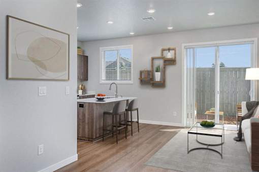 A modern kitchen with a dining table and chairs.