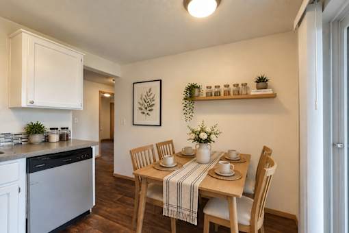 A kitchen with a dining table set for four.