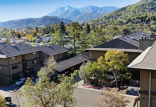 A mountain range is in the background of a residential area.