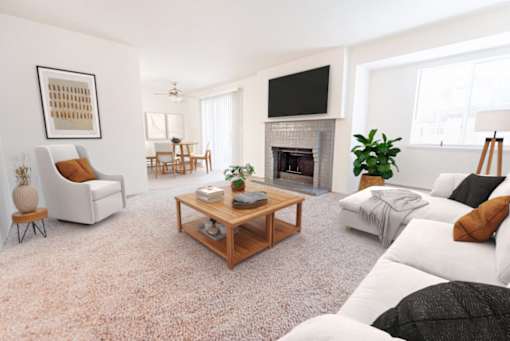 A living room with a fireplace, a couch, a chair, a coffee table, and a television.