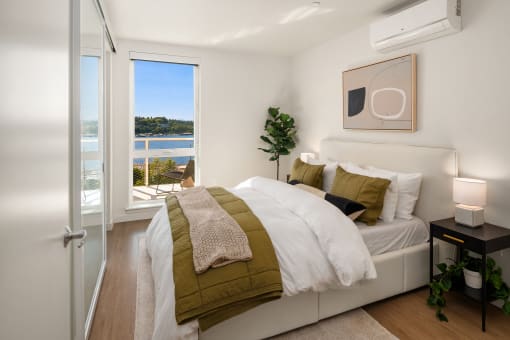 a bedroom with a large window and a bed at Liza Apartments, Seattle, Washington