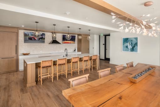 a kitchen and dining room with a wooden table and chairs at Liza Apartments, Seattle