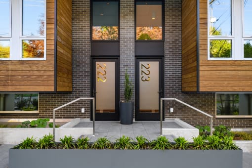 the facade of a building with brick and glass doors at Liza Apartments, Seattle