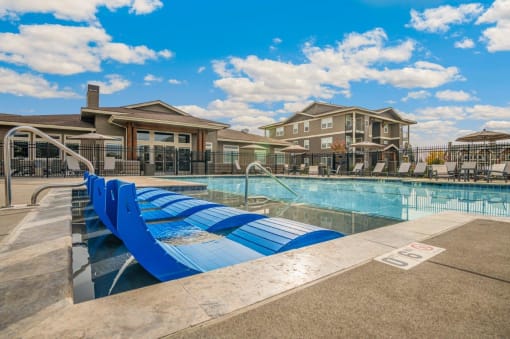 RedPoint Apartments Pool with Lounge Chairs