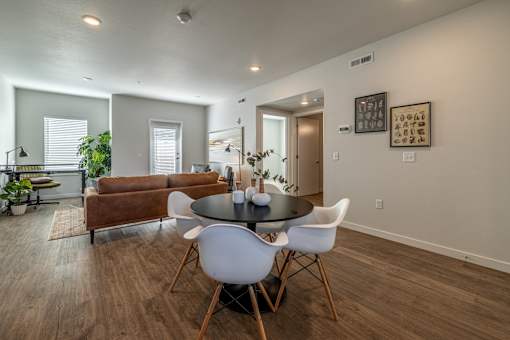 A dining room with a round table and chairs.