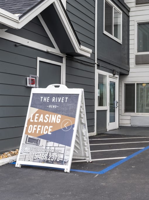 the rivet leasing office sign in front of a building