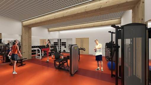 A gym with a red floor and white walls.