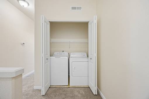 A laundry room with a washer and dryer in it at Springwater Crossing apartments in Gresham, Oregon 97030