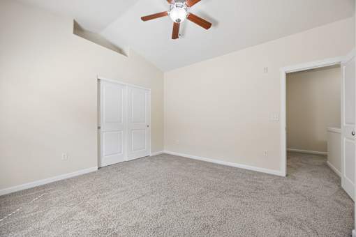 A room with a ceiling fan and carpeted floor at Springwater Crossing apartments in Gresham, Oregon 97030