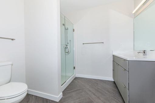 A white bathroom with a walk in shower.