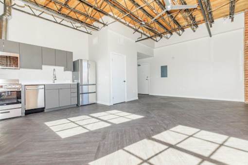 A kitchen with a dining table and a refrigerator.