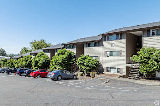 Exterior view of property and on-site parking lot at The Groove apartments in the Hazel Dell 98665 neighborhood in Vancouver, Washington.