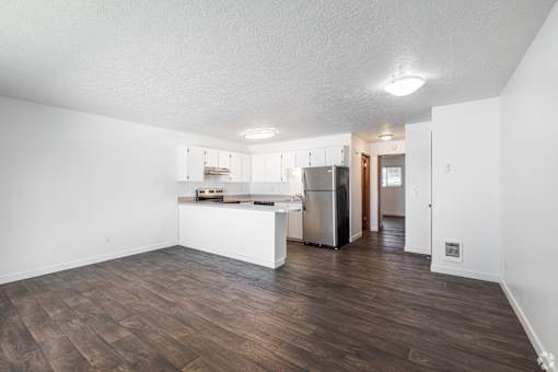 Photo of open-concept kitchen with stainless steel appliances and overhead lighting at The Groove apartments in the Hazel Dell 98665 neighborhood in Vancouver, Washington.