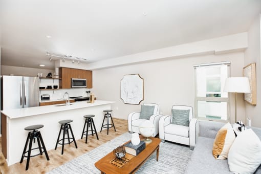 a living room with a kitchen and a couch at The Hayes on Stone Way, Seattle, WA