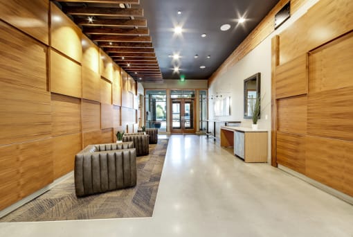 The Hayes on Stone Way Apartments large lobby with wood paneling and seating and a counter at The Hayes on Stone Way, Seattle, WA, 98103