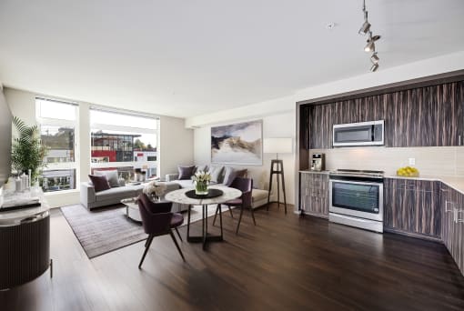 a living room with a kitchen and a table and chairs at The Hayes on Stone Way, Washington, 98103
