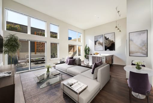 The Hayes on Stone Way Apartments  living room with a couch and a coffee table and large windows at The Hayes on Stone Way, Seattle, WA