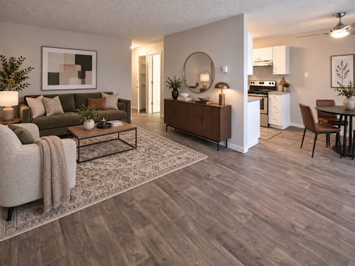 A living room with a brown coffee table and a grey rug.