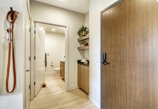 a hallway with wooden floors and a wooden door