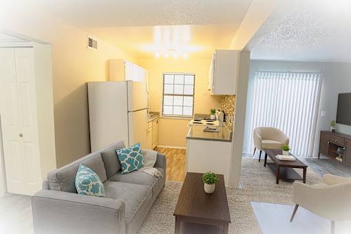 A living room with a grey couch and a wooden coffee table.