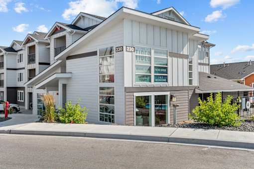 A modern apartment building with the number 230230 on the front.