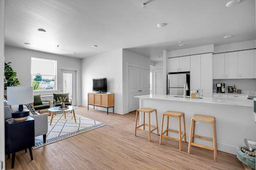 A modern living room with a bar area and a dining table.