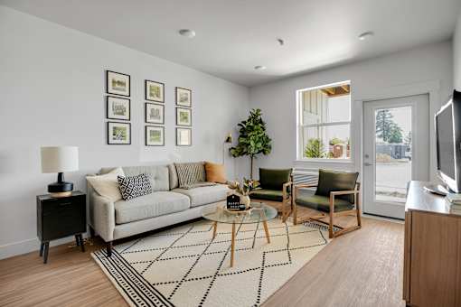 A living room with a couch, chair, and a coffee table.