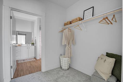 A room with a white wall and a wooden floor.