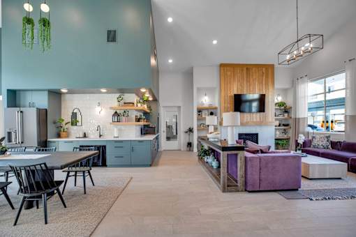 A modern kitchen with a dining table and chairs.