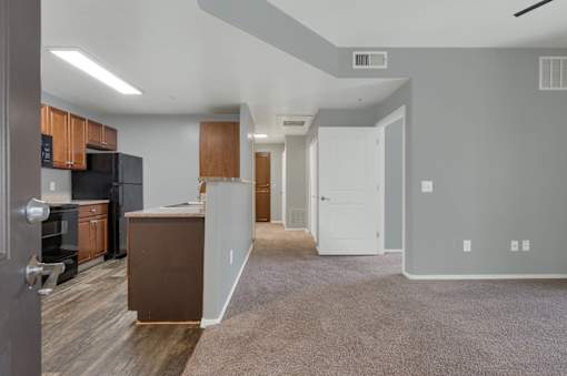 A kitchen area with a refrigerator, oven, and microwave.