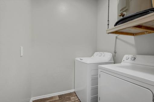 A white toilet with the number 553 written on it is in a small room.
