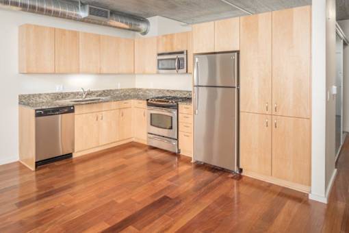 A kitchen with wooden cabinets and stainless steel appliances.