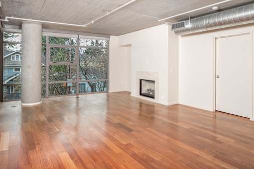 A room with wooden floors and a fireplace.