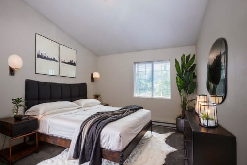 a bedroom with a bed and a potted plant
