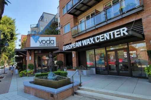 a large brick building with a sign that reads vodafone european wax center