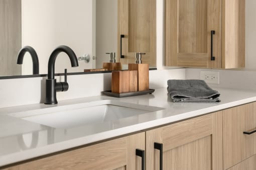 a kitchen with a sink and a black faucet at Liza Apartments, Washington