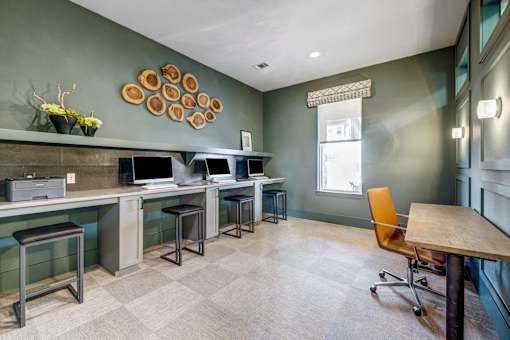 A room with a green wall and a wooden table.