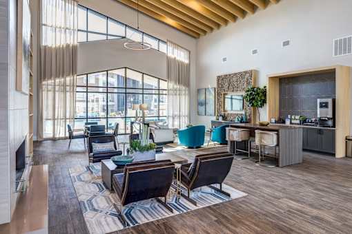 A modern living room with a large window and a wooden ceiling.
