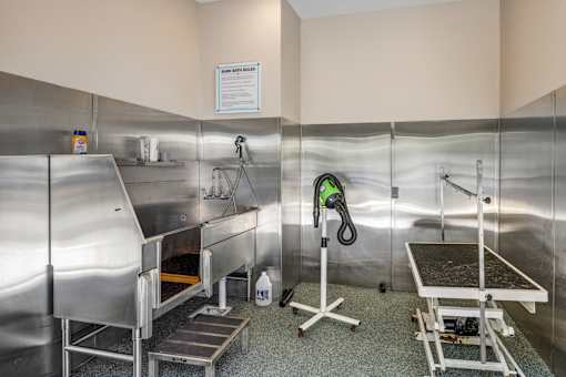 A cleaning station with a vacuum cleaner and a sign on the wall.