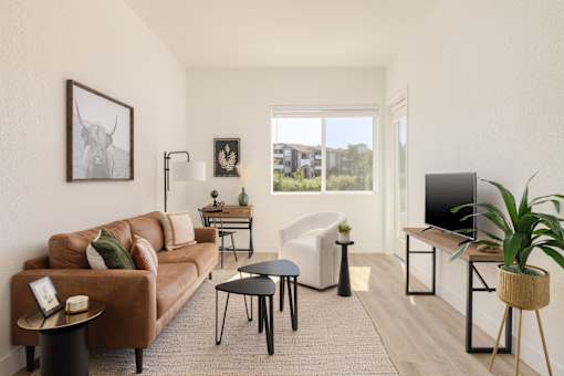 a living room with a brown couch and a television