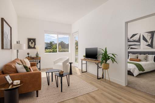 a living room with a couch and a tv and a bedroom with a bed