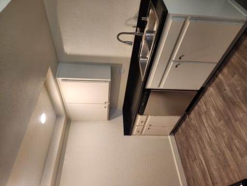 an overhead view of a kitchen with a refrigerator and a microwave