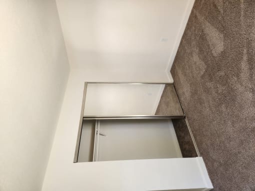 an overhead view of an open closet in a bathroom with a window
