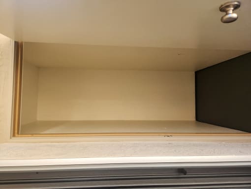 the inside of a wardrobe with a door open