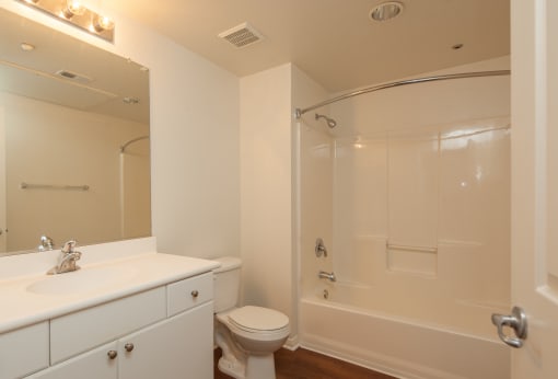 a bathroom with a shower and a sink and a toilet