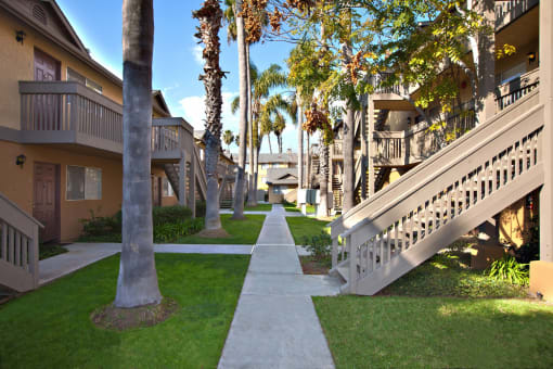the walkway between the units at the club at highland park apartments