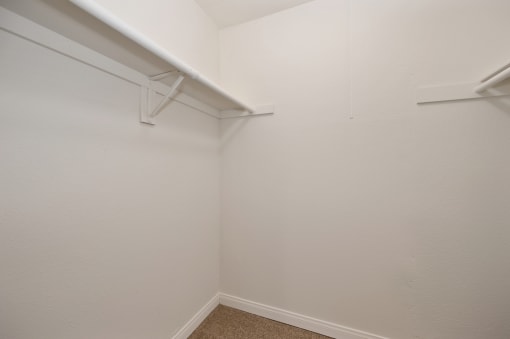 an empty closet with a hanger on the wall