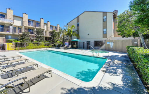 our apartments have a swimming pool and a patio with chairs