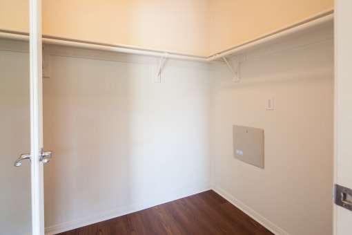 an empty room with white walls and a door
